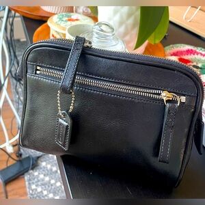 Coach black leather make up bag. Two zippers, inside pockets & w/ mini tag. EUC.